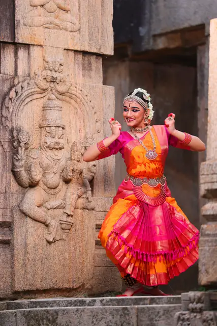A pose before an ancient stone carving