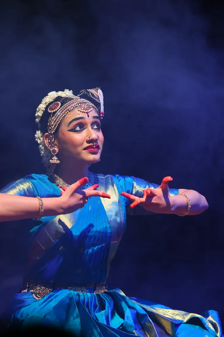An expressive dual-hand mudra mid-performance
