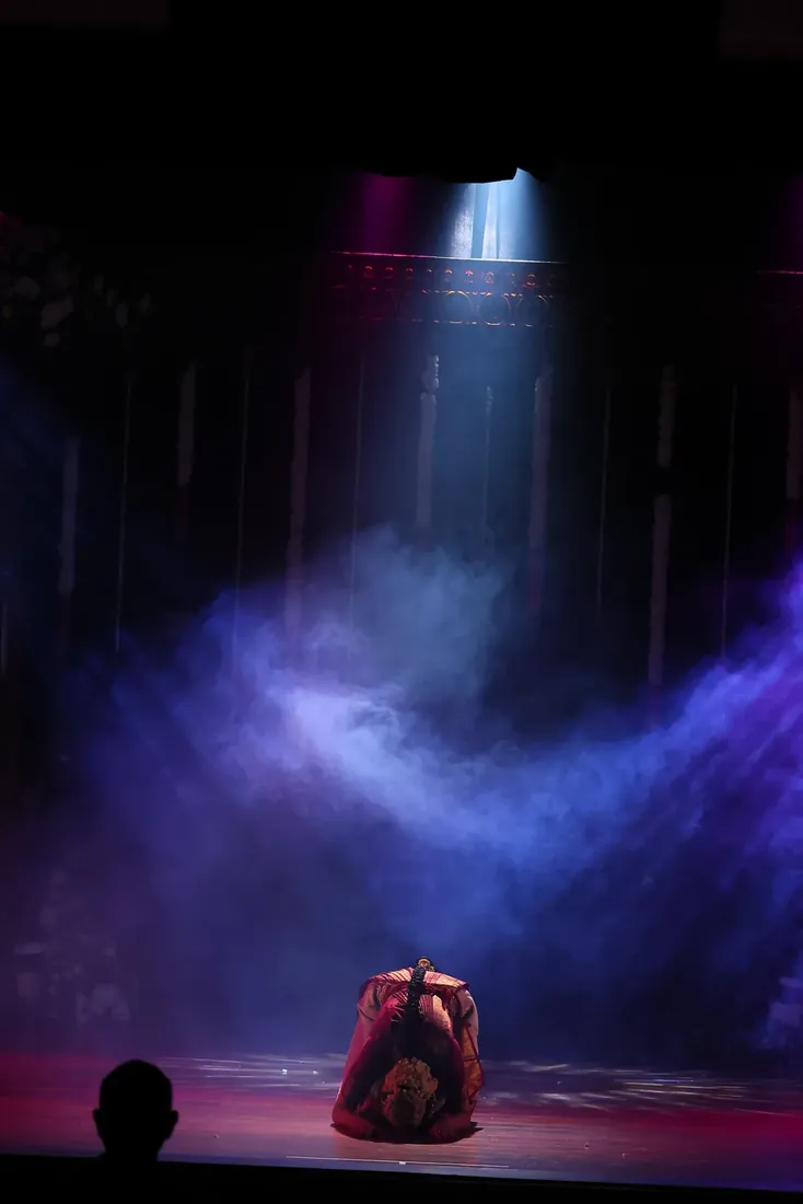 A dramatic closing bow beneath the spotlight
