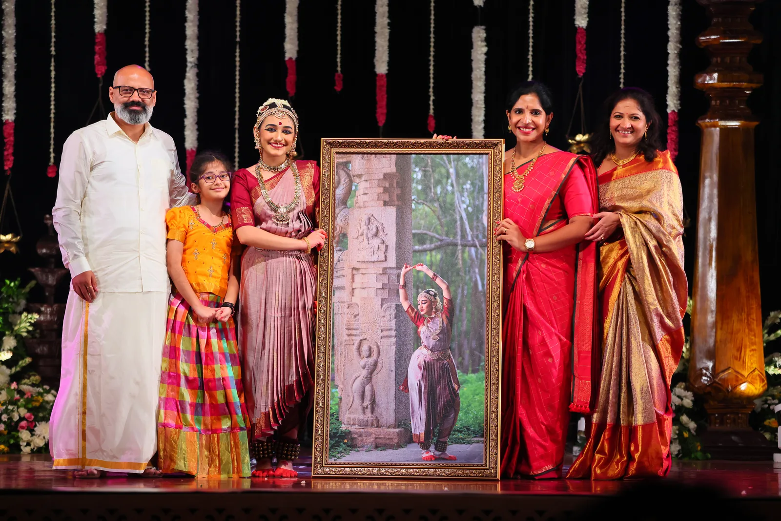 Ananya's family with a framed portrait from her shoot