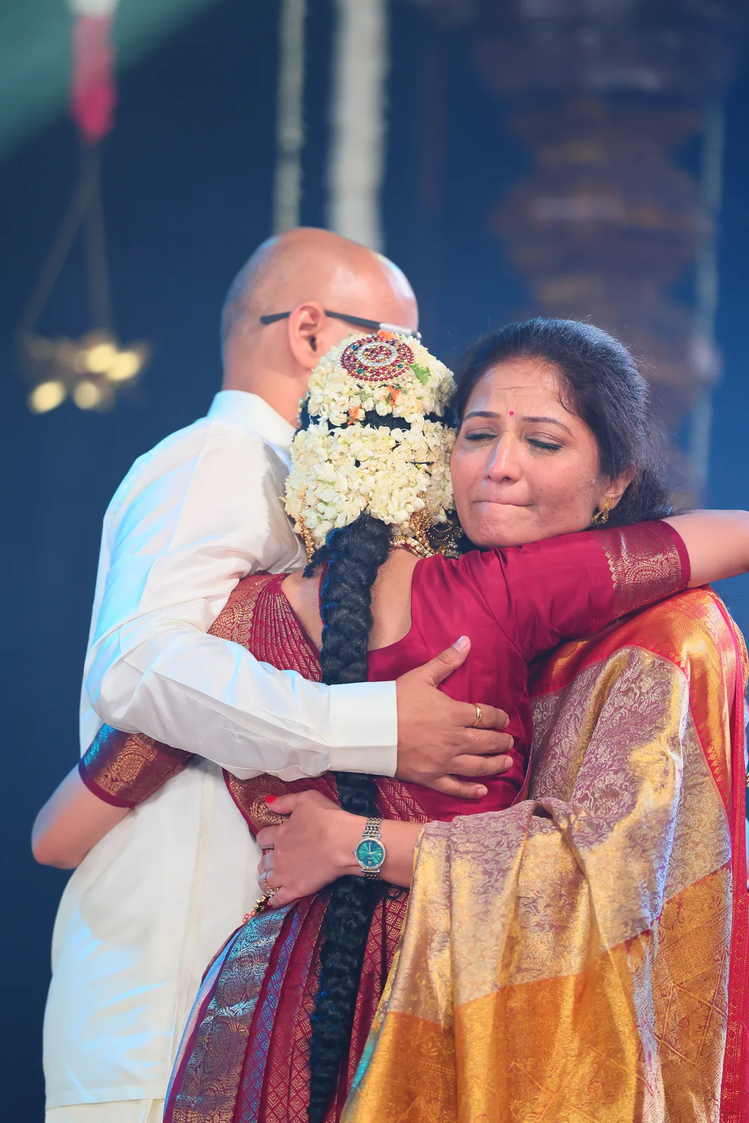 A joyful embrace with her parents