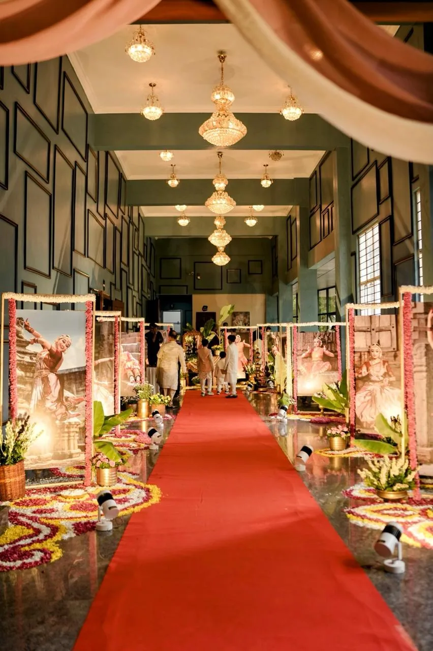 The red carpet entrance, lined with portraits