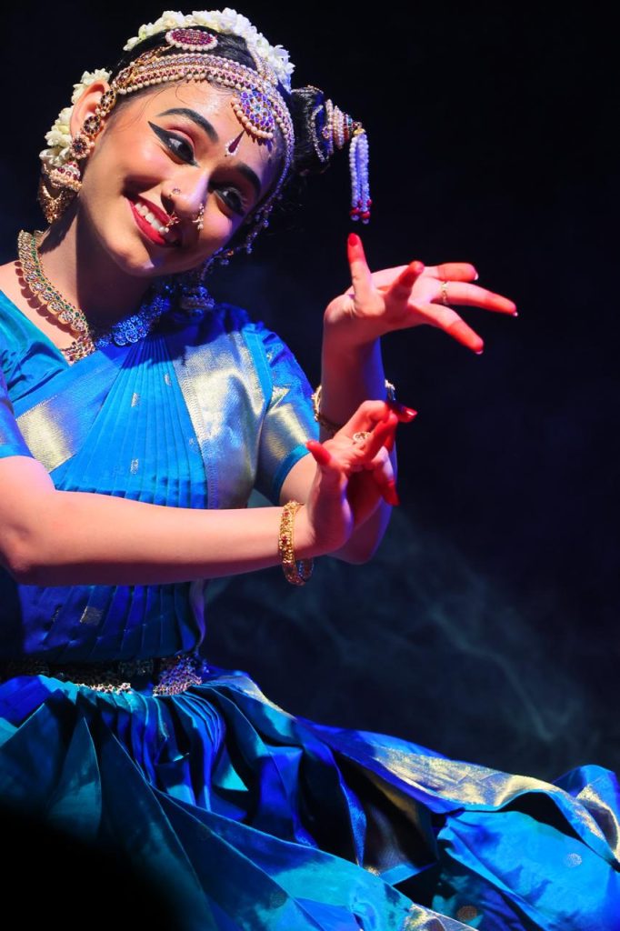 Close portrait of Ananya using expressive hand gestures