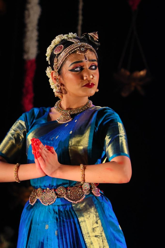 Ananya depicting a reflective expression with joined palms