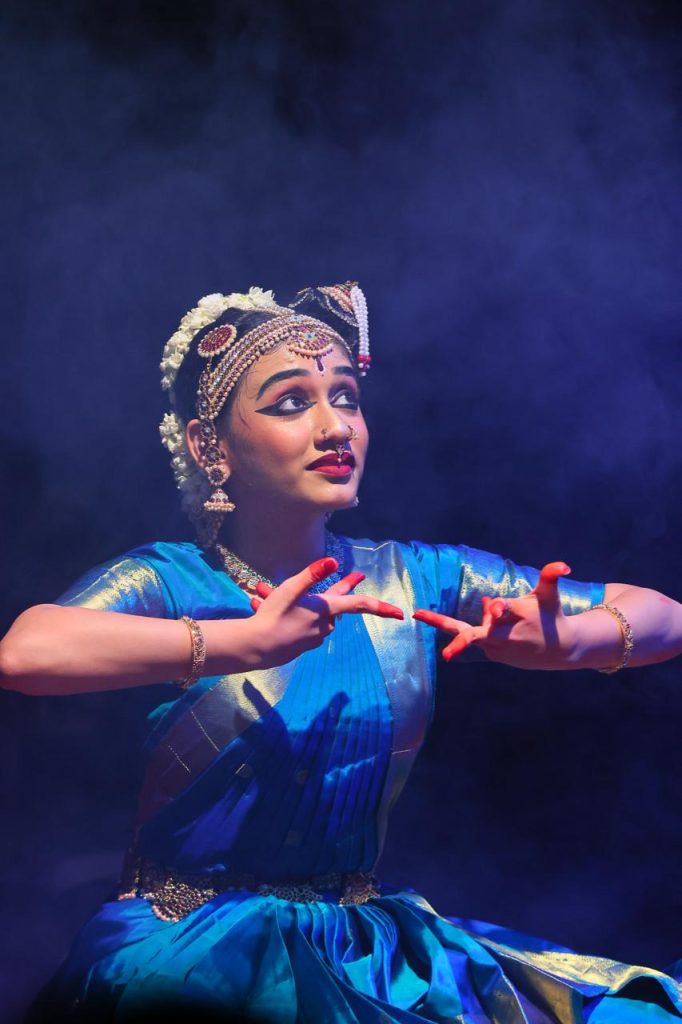 Ananya seated in an expressive storytelling gesture